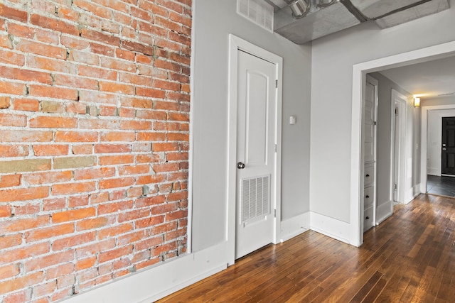 109 Leicester Ct, Detroit, MI 48202 - hallway featuring brick wall, dark wood finished floors, and baseboards