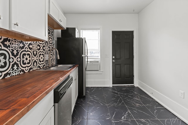 109 Leicester Ct, Detroit, MI 48202 - kitchen with wooden counters, stainless steel appliances, dark marble finish floors, a sink, and tasteful backsplash