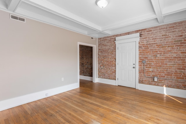 109 Leicester Ct, Detroit, MI 48202 - empty room with baseboards, coffered ceiling, brick wall, beam ceiling, and light wood finished floors