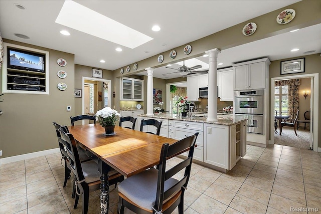 62 Robertson Ct, Clarkston, MI 48346 - dining room with decorative columns, a skylight, recessed lighting, a ceiling fan, and light tile patterned floors