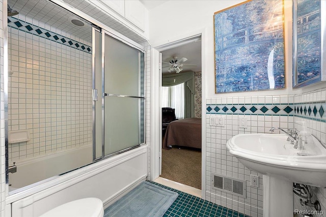 62 Robertson Ct, Clarkston, MI 48346 - bathroom featuring tile patterned flooring, combined bath / shower with glass door, ensuite bathroom, tile walls, and ceiling fan