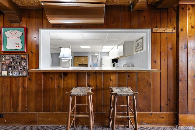 62 Robertson Ct, Clarkston, MI 48346 - bar area with wooden walls and a drop ceiling