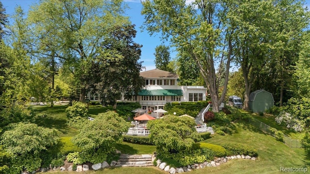 62 Robertson Ct, Clarkston, MI 48346 - view of green lawn featuring view of scattered trees and stairs