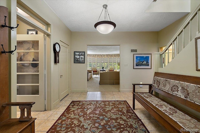 62 Robertson Ct, Clarkston, MI 48346 - entrance foyer with light tile patterned flooring, a textured ceiling, and baseboards