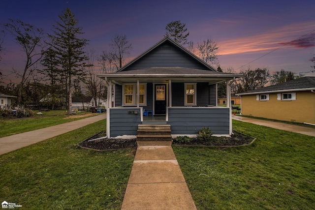 bungalow-style house featuring a lawn and a porch
