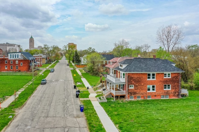 view of road featuring sidewalks, curbs, and stairway