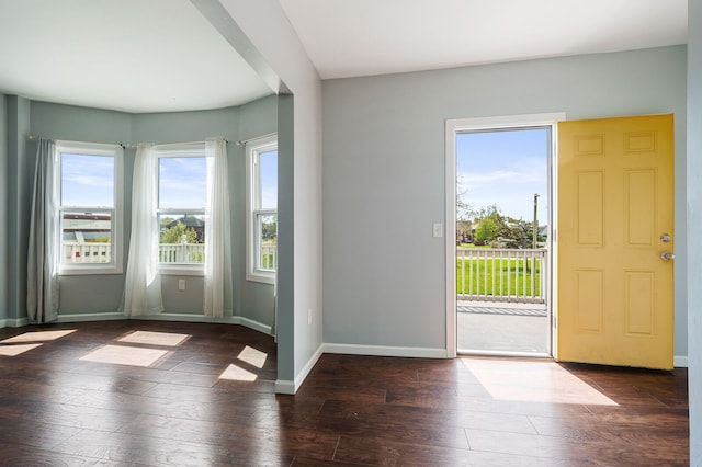 interior space featuring baseboards and hardwood / wood-style floors