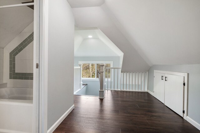 bonus room with recessed lighting, baseboards, lofted ceiling, and dark wood-type flooring