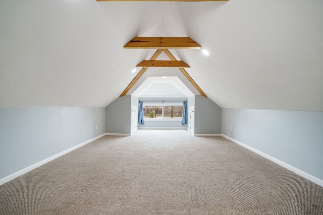 bonus room with baseboards, vaulted ceiling with beams, and carpet flooring