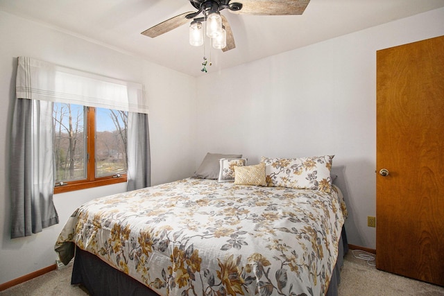 carpeted bedroom with baseboards and ceiling fan