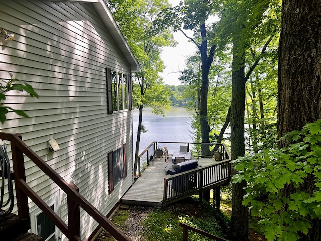 6302 E Interlochen Rd, Fountain, MI 49410 - view of property exterior featuring a deck with water view