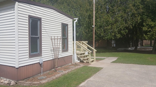 view of property exterior with a yard