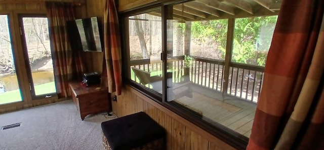 sunroom featuring visible vents and a wealth of natural light