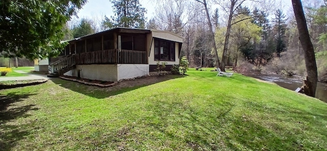 view of property exterior with a sunroom, a lawn, and stairs