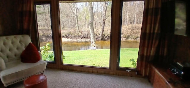 entryway featuring a water view and carpet
