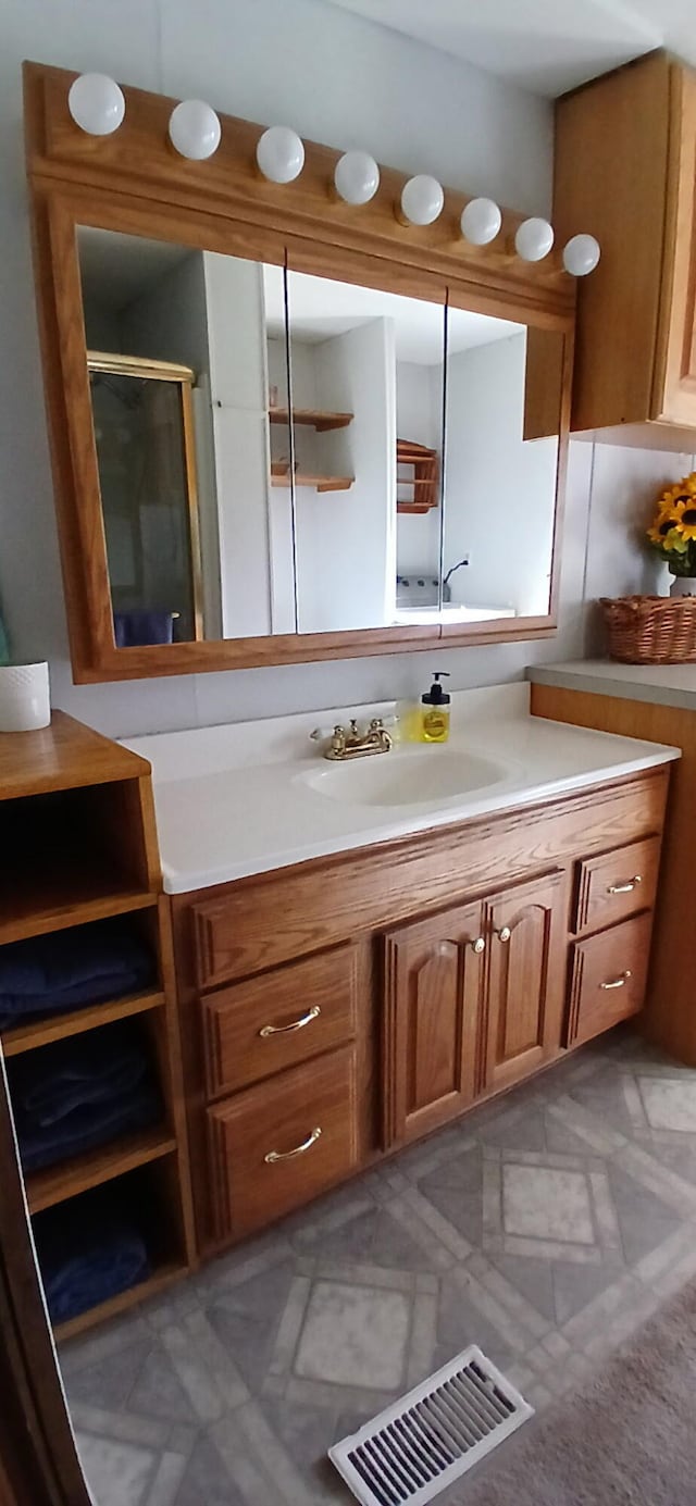 full bath featuring vanity and a stall shower