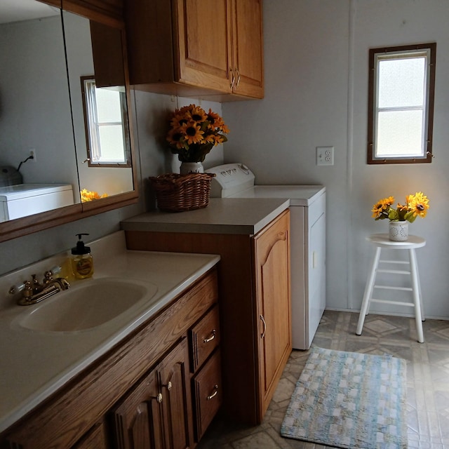 laundry room with a sink and washer and clothes dryer