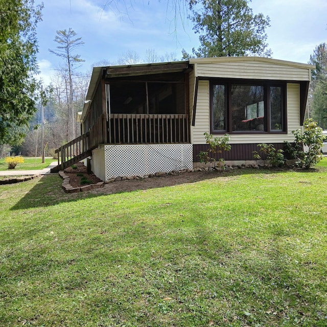 view of front of home featuring a sunroom and a front yard