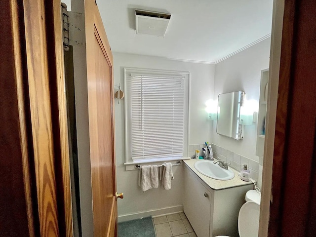 1514 Golden Ave, Ann Arbor, MI 48104 - half bathroom with vanity, toilet, tile patterned floors, baseboards, and ornamental molding
