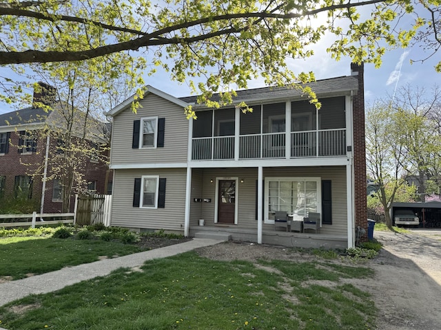 1514 Golden Ave, Ann Arbor, MI 48104 - view of front of home with fence, covered porch, a chimney, and a front yard