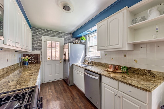 kitchen with appliances with stainless steel finishes, dark wood-style floors, plenty of natural light, and white cabinets