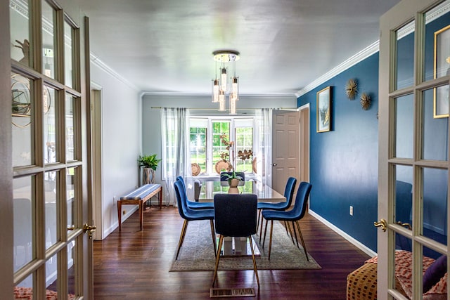 dining area featuring crown molding, baseboards, dark wood-style flooring, and french doors