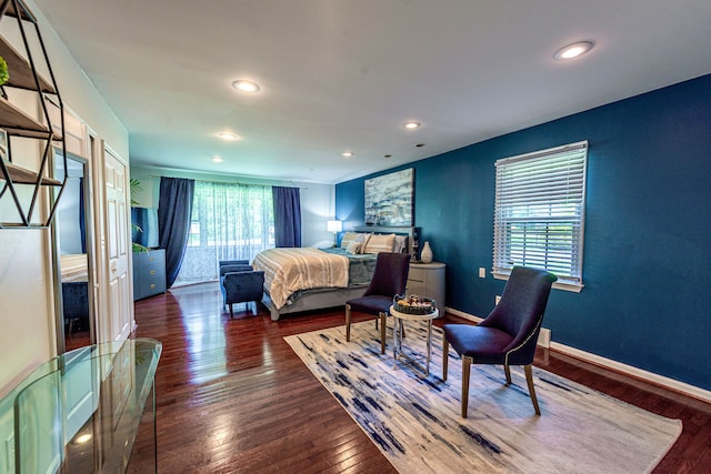 bedroom featuring wood finished floors, recessed lighting, and baseboards