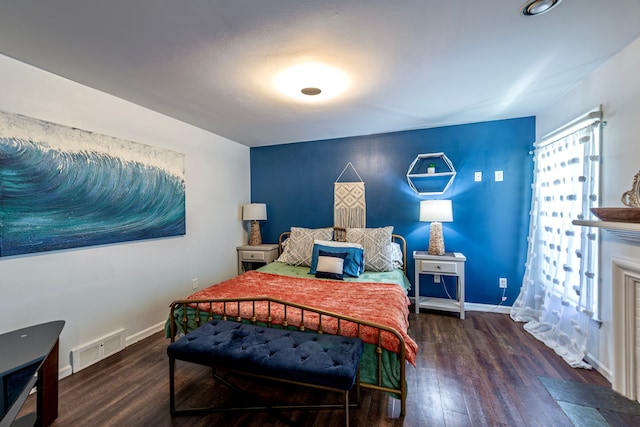 bedroom featuring wood finished floors and baseboards