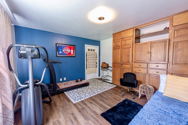 bedroom with dark wood-style flooring