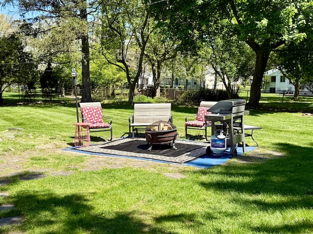 view of yard with a fire pit