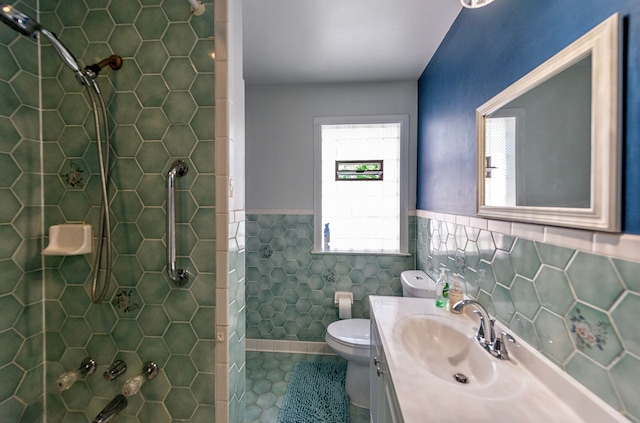 full bath with tile walls, vanity, wainscoting, toilet, and tile patterned flooring