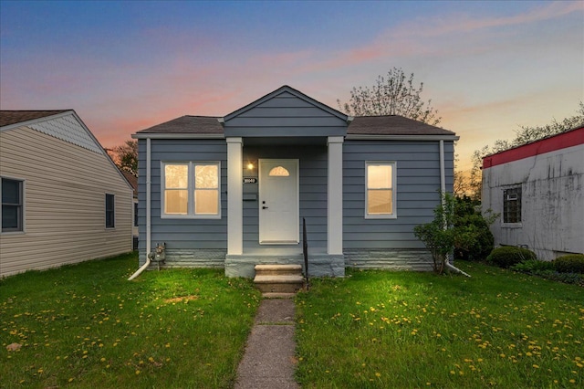 20040 E 8 Mile Rd, Harper Woods, MI 48225 - view of front of house featuring a yard and a shingled roof