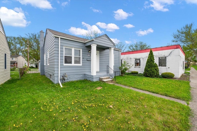 20040 E 8 Mile Rd, Harper Woods, MI 48225 - view of front of house featuring a front lawn and a chimney