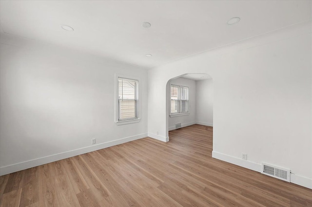 20040 E 8 Mile Rd, Harper Woods, MI 48225 - spare room featuring arched walkways, baseboards, light wood finished floors, and recessed lighting