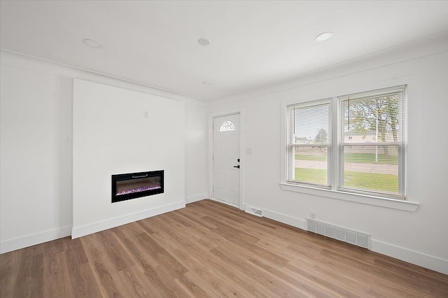 20040 E 8 Mile Rd, Harper Woods, MI 48225 - unfurnished living room with a glass covered fireplace, light wood-style floors, baseboards, and recessed lighting