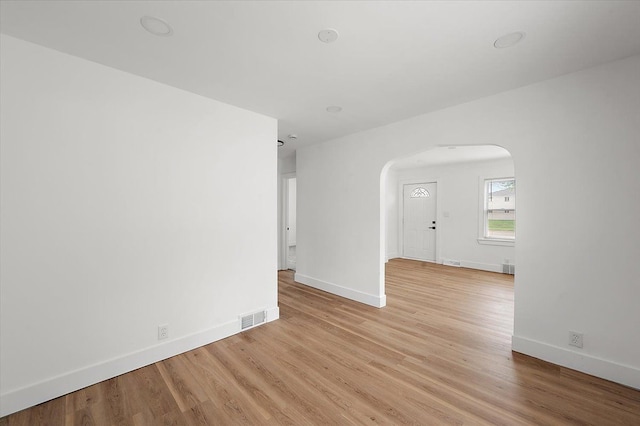 20040 E 8 Mile Rd, Harper Woods, MI 48225 - unfurnished room with arched walkways, baseboards, and light wood-type flooring