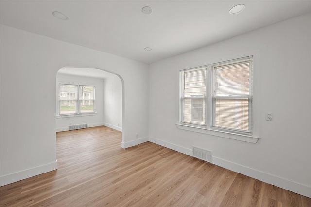 20040 E 8 Mile Rd, Harper Woods, MI 48225 - unfurnished room featuring arched walkways, baseboards, light wood-style flooring, and recessed lighting
