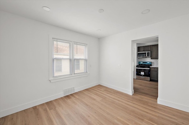 20040 E 8 Mile Rd, Harper Woods, MI 48225 - spare room with baseboards and light wood-style floors