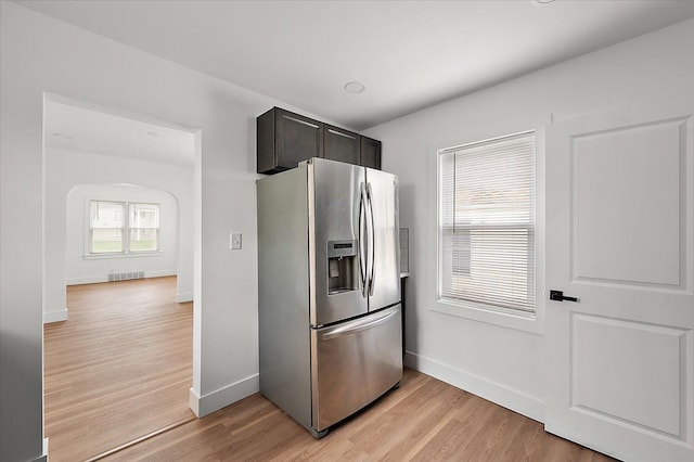 20040 E 8 Mile Rd, Harper Woods, MI 48225 - kitchen with stainless steel fridge, light wood finished floors, and baseboards