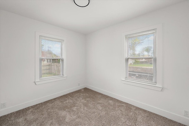 20040 E 8 Mile Rd, Harper Woods, MI 48225 - empty room featuring plenty of natural light, light carpet, and baseboards