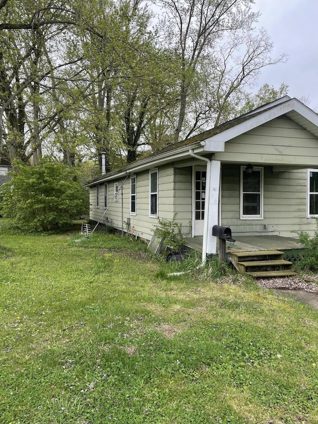 view of property exterior featuring a yard and a porch