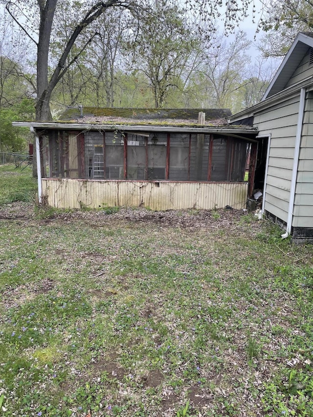 view of home's exterior with a sunroom