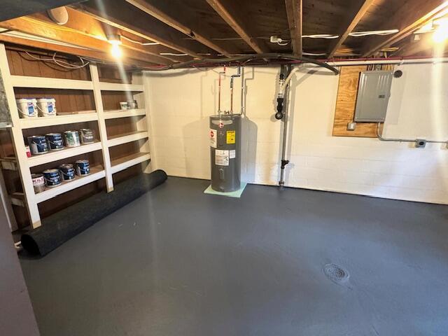 unfinished basement featuring water heater and electric panel