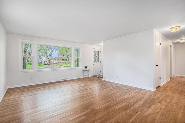 interior space with visible vents, light wood-style floors, and baseboards