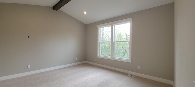 empty room featuring vaulted ceiling with beams, baseboards, visible vents, and a healthy amount of sunlight