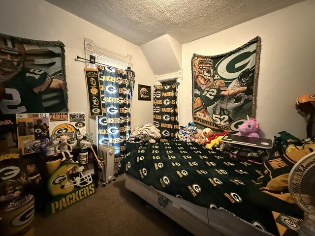 bedroom featuring carpet flooring, a textured ceiling, and lofted ceiling