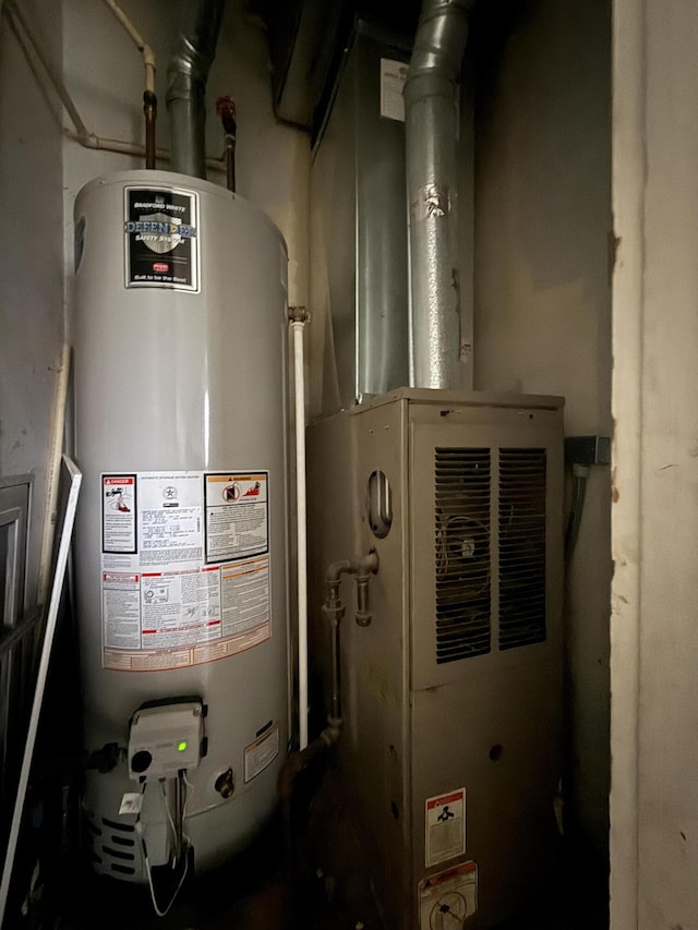 utility room featuring water heater