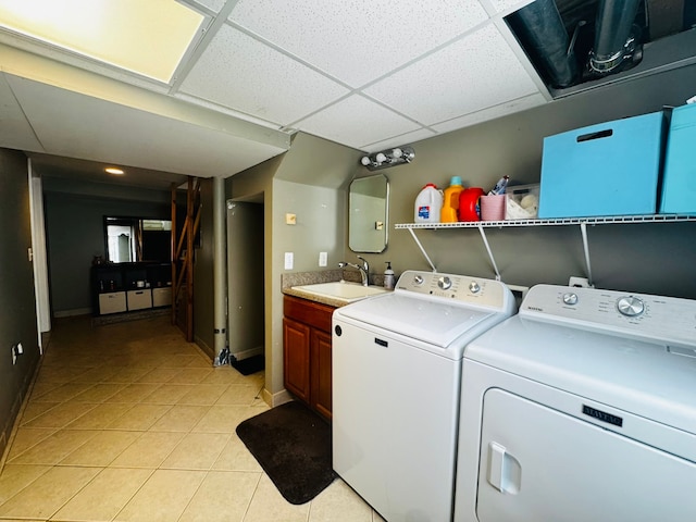 laundry room with a sink, separate washer and dryer, cabinet space, and light tile patterned floors