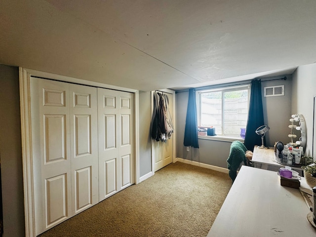 carpeted bedroom featuring visible vents and baseboards