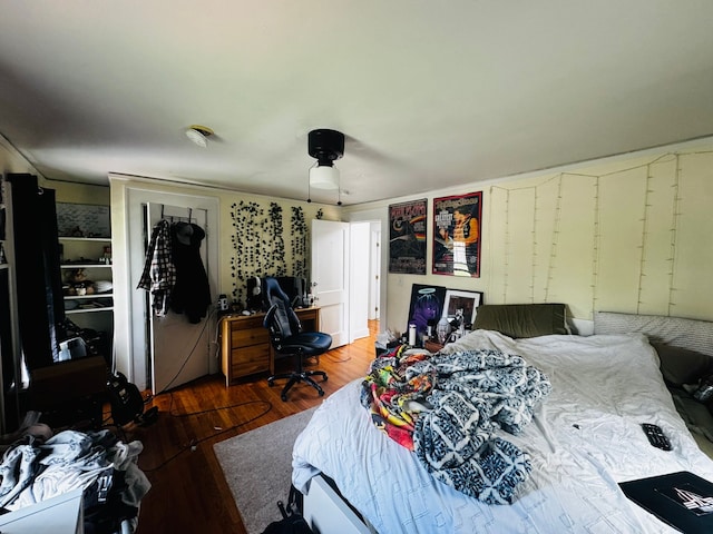 bedroom with a ceiling fan and wood finished floors